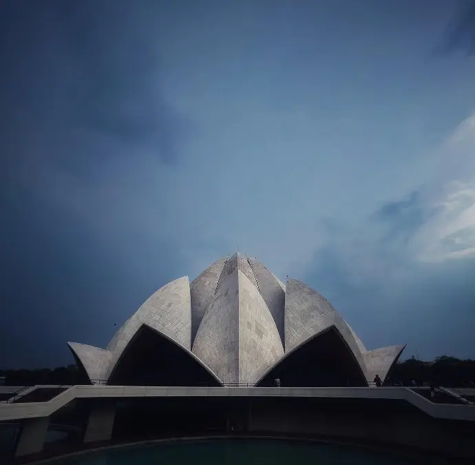 Photograph of the Lotus Temple in New Delhi, showcasing its iconic lotus-shaped architecture and serene surroundings.